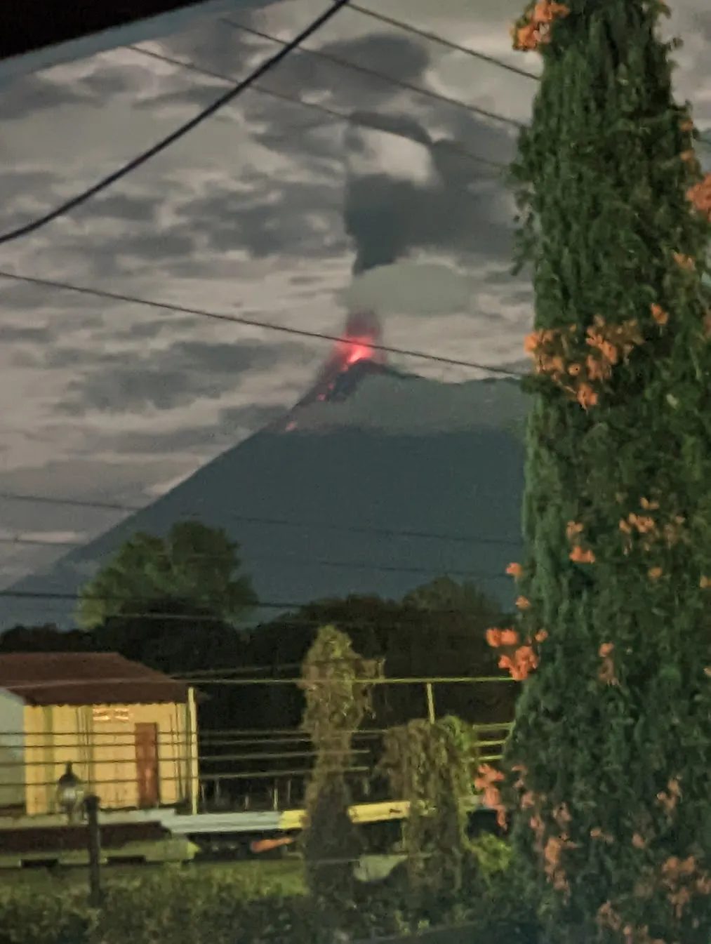 Volcan de Fuego erupting, viewed at night from a bedroom window in Antigua Guatemala