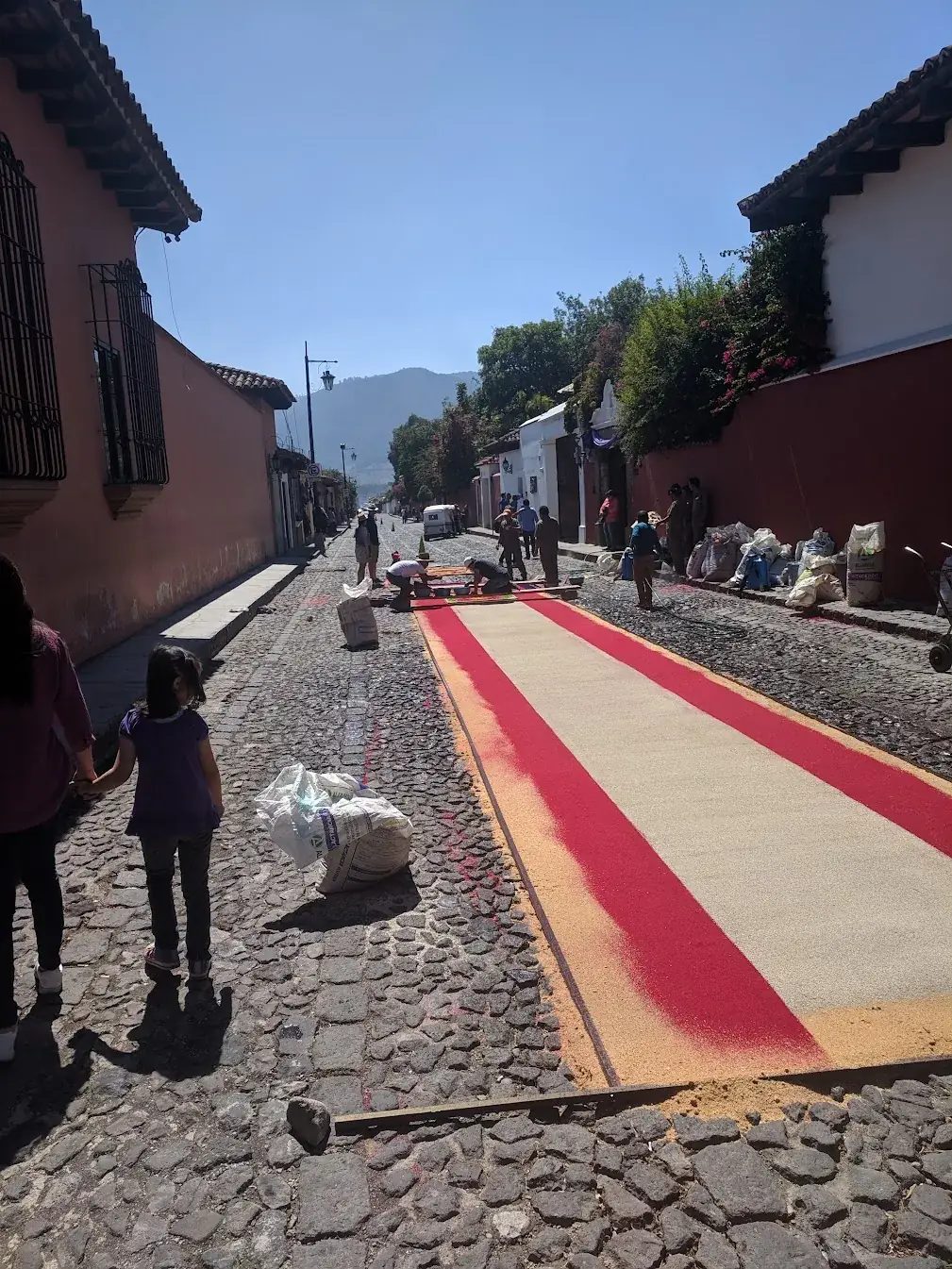 Semana Santa sawdust alfombra (carpet) being assembled on a Guatemalan street