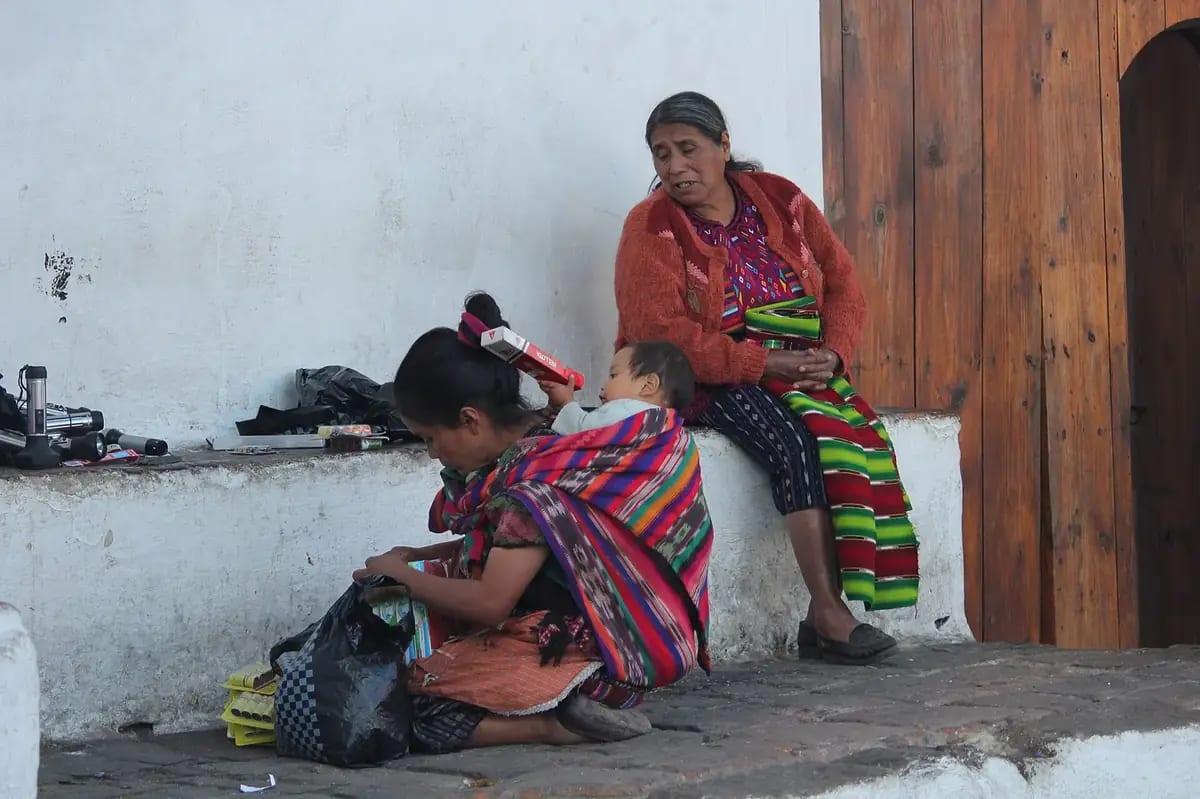 Three generations of a Maya family at the Chichicastenango market, Quiche, Guatemala