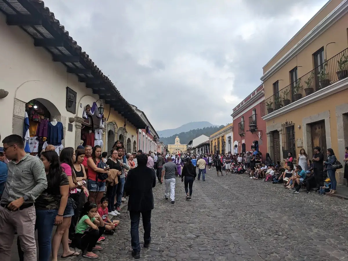 Crowds lining a street in Antigua waiting for a Good Friday procession